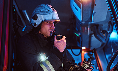 firefighter-in-truck-on-radio-public-safety-errcs-systems-los-angeles-las-vegas-san-diego<br />
