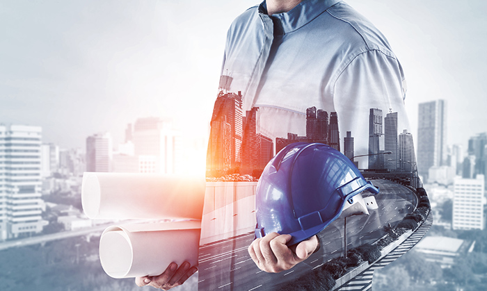 technician-with-hardhat-and-plans-for-errcs-system-distributed-antenna-system-and-small-cell-graystone-communications